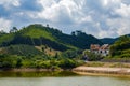 View of blue sky, white clouds and green hills and forest at outdoor reservoir Royalty Free Stock Photo