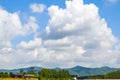 View of blue sky, white clouds and green hills and forest at outdoor reservoir Royalty Free Stock Photo