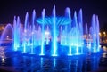 View of blue water fountain with LED lights at night generative AI Royalty Free Stock Photo