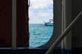 View of ferry, sea and sky through metal ferry door Royalty Free Stock Photo