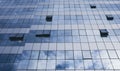 View of blue windows in a skyscraper modern offices building -  concept of people at work at life - openand close windows with sky Royalty Free Stock Photo