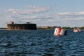 View from a boat on Fort Alexander the First in Kronstadt in the waters of the Gulf of Finland. Raid barrels for parking