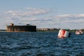 View from a boat on Fort Alexander the First in Kronstadt in the waters of the Gulf of Finland. Raid barrels for parking