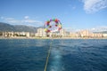 View from a boat to tied parachute with woman