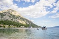 View on boats, beach and mountains behind in Gradac, Croatia. Popular destination. Royalty Free Stock Photo