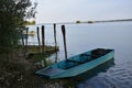 View of boats docked by the coast of a lake before the blue skyline Royalty Free Stock Photo