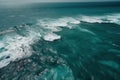 a view of a body of water from a plane flying over the ocean with a lot of foamy water on the bottom of the water