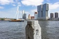 A view of a bollard along the river Maas and the imposing buildings at the Erasmus bridge in Rotterdam