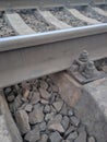 View on bolts of fastening of railway rails to concrete cross ties. Rusty and old bolts and nuts for fixing rail and sleepers. The Royalty Free Stock Photo