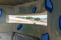 View of the border dividing strip through the embrasure in the concrete security separation fence on the border between Israel and Royalty Free Stock Photo