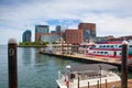 View of Boston from harbor and rowes wharf at sunset