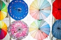 View from the bottom of colorful umbrellas cover in narrow city alley