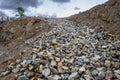 View from the bottom of a recently dug residential foundation up a gravel slope