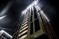 View bottom up on a tall modern building at night Royalty Free Stock Photo