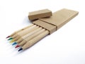 View of box of colored wooden pencils with separate lid and recycled paper. Biodegradable school supplies. Crayons with eco-