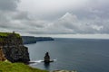 View of the Branaunmore sea stack and boats sailing in the ocean in the Cliffs of Moher