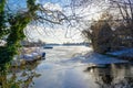 View through branches to the frozen Dahme river in Berlin Koepenick