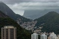 View of Brazilian city showing favelas, hotels, condos, apartments in a mountain range in Rio de Janeiro on a cloudy day