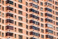 View of brick wall red contemporary apartment building with windows and balconies closeup Royalty Free Stock Photo