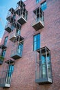 View of the brick wall with windows and balconies of the Art House apartment complex, Tessinsky Lane