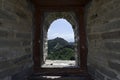 View through a brick window of a Fortress Guard Tower of Mutianyu, a section of the Great Wall of China during summer Royalty Free Stock Photo