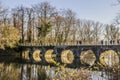 View of a bridge with its arches reflecting in the lake Royalty Free Stock Photo