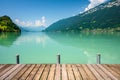 View of Brienz lake with clear turquoise water. Wooden pier. Brienz lake in the village of Iseltwald, Switzerland