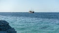 View of bright blue ocean with old vintage ship, rocky shore. Tropical paradise, Caribbean sea, Cancun Mexico. Royalty Free Stock Photo