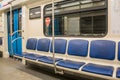 Contemporary inside space of the underground railway carriage with empty seats. Royalty Free Stock Photo