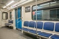 Contemporary inside space of the underground railway carriage with empty seats. Royalty Free Stock Photo