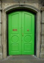 View of brightly colored traditional English green house door. Entrance door Royalty Free Stock Photo