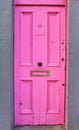 View of brightly colored traditional English pink house door. Entrance door Royalty Free Stock Photo