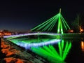 View of a brightly lit bridge in neon color in the winter park