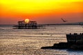 View of Brighton West Pier in the sea before the orange sunset sky Royalty Free Stock Photo