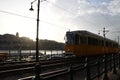 View of the Buda Castle during sunset with an approaching tram from Pest side