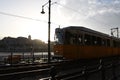 View of the Buda Castle during sunset with an approaching tram from Pest side