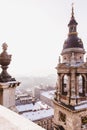 View of Budapest from St. Stephens Basilica, Budapest, Hungary on a snowy foggy day. Ferris wheel Budapest eye seen in the Royalty Free Stock Photo