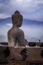 View of Buddha statue on a misty morning at Borobudur Temple