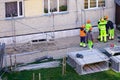 view of builders discussing plans before scaffolding assembly