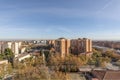 View of the building facades and rooftops of the city on a sunny winter day with deciduous trees about to fall