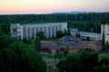 View of the building of the sanatorium and the unfinished hydropathic center on the background of the forest. Royalty Free Stock Photo