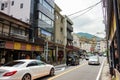 View of building and traffic at Hakone-Yumoto station with cars on road and people on sidewalk