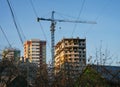 A view of building that is under construction with crane near it against blue sky Royalty Free Stock Photo