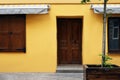 View of building with wooden door and sun blinds over windows . Exterior design Royalty Free Stock Photo