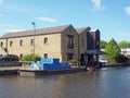 Buildings around the brighouse basin with moored boat on the calder and hebble navigation canal in calderdale west Royalty Free Stock Photo