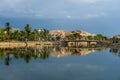 View of buildings, bridge over river water and overcast sky in the old city of Hoi An, Vietnam