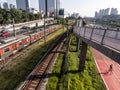 View of buildings, CPTM train, traffic of vehicles and river in Marginal Pinheiros River Avenue