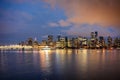 View of buildings illuminated in the city on coastline from Stanley park at Vancouver Royalty Free Stock Photo
