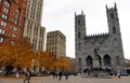 The view of buildings and Notre Dame church surrounded by fall foliage near Place d`Armes, Montreal, Canada Royalty Free Stock Photo