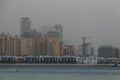 View of the buildings and skyscrapers under construction over the sea, hiding in the evening mist. Dubai real estate Royalty Free Stock Photo